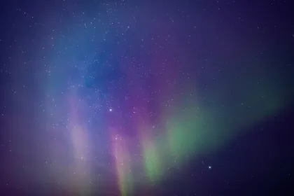 Aurora borealis, polar lights with Milky Way stars.