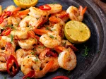 Prawns Shrimps roasted on pan with lemon and garlic