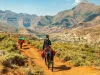 Female tourist riding on a Basotho Poney in Lesotho