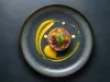 Elegant gourmet dish with artistic presentation on dark plate