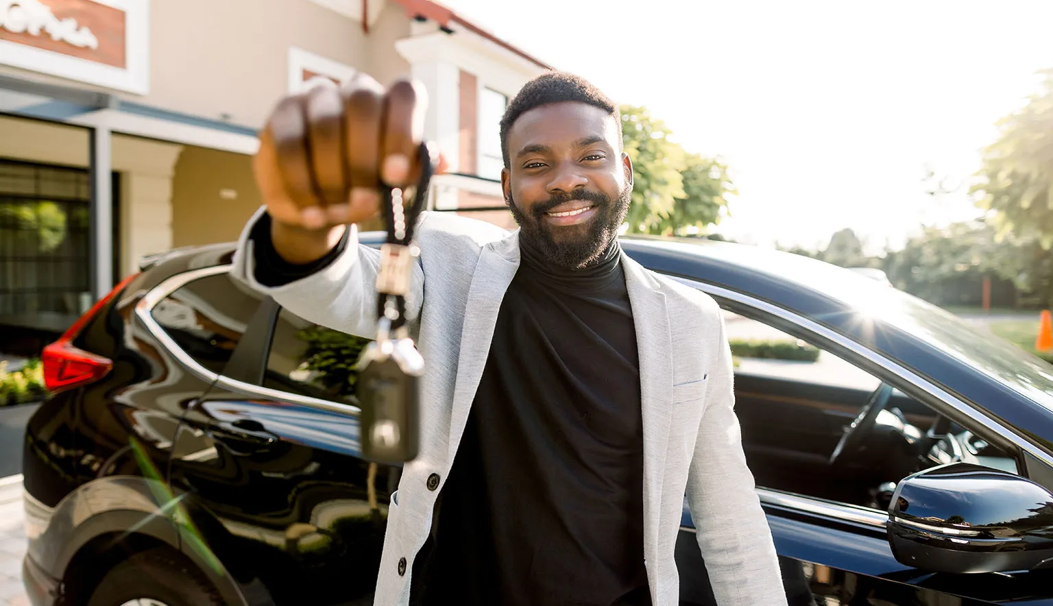 Portrait of man car seller holding car keys.