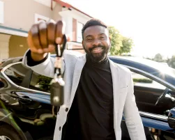 Portrait of man car seller holding car keys.