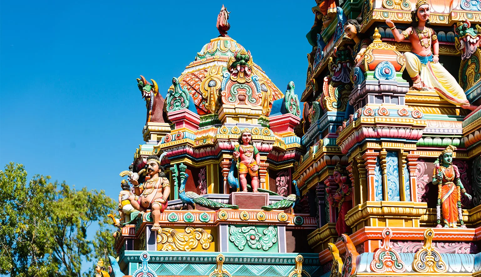 Colourful Indian temple in Mauritius Island. Close-up on sculptures and statues of deities.