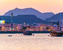View of coastline of Muttrah district of Muscat during sunset, Oman.