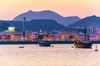 View of coastline of Muttrah district of Muscat during sunset, Oman.