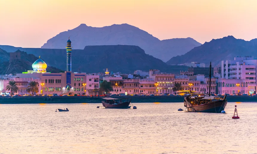 View of coastline of Muttrah district of Muscat during sunset, Oman.