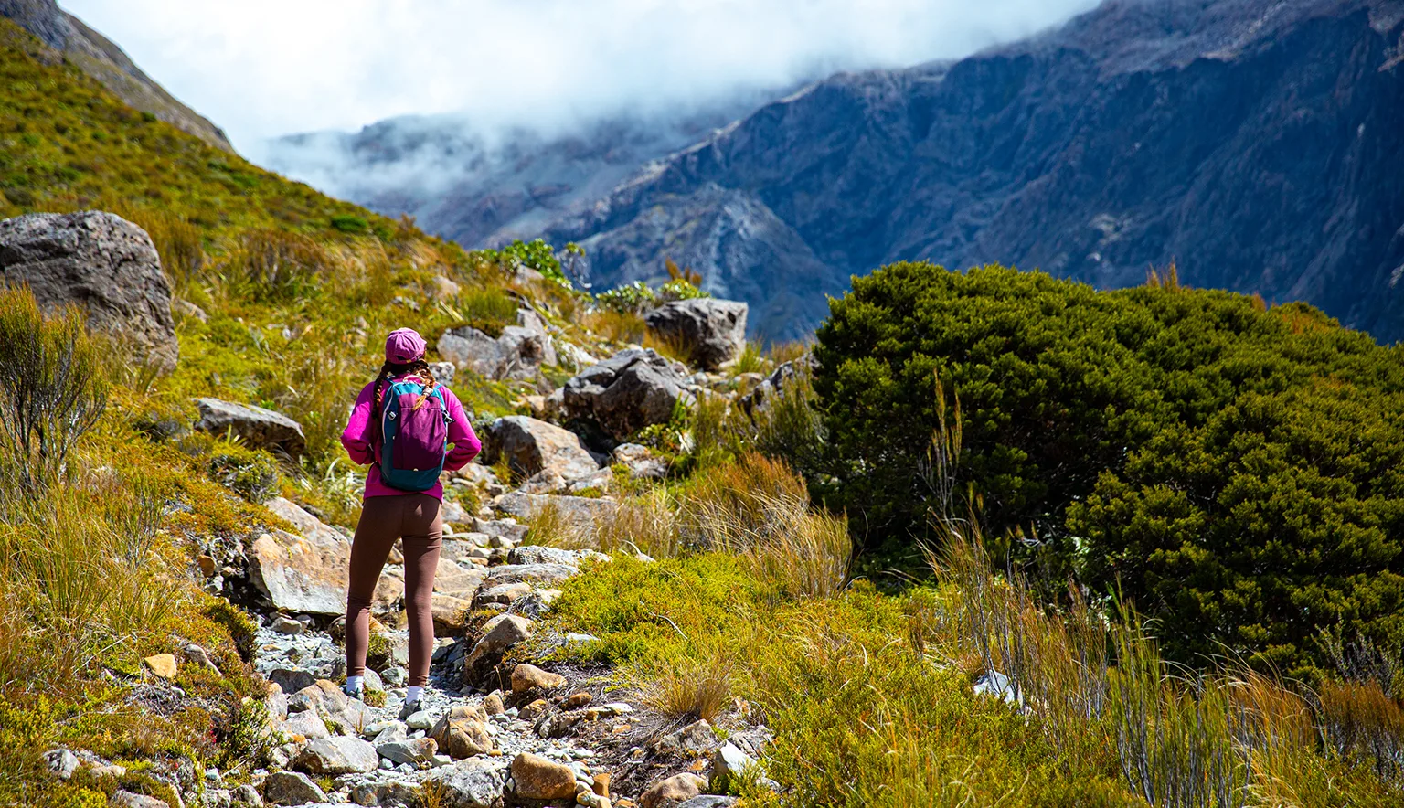 hiker girl enjoys a scenic path in southern alps - otira valley