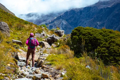 hiker girl enjoys a scenic path in southern alps - otira valley