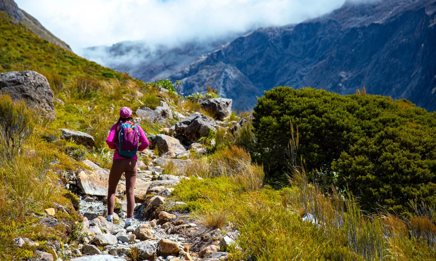 hiker girl enjoys a scenic path in southern alps - otira valley