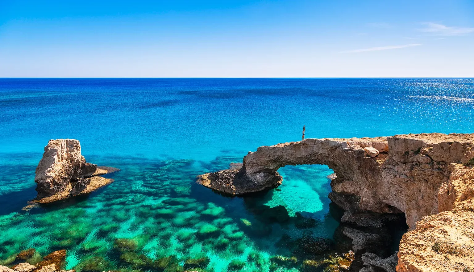 Woman on the beautiful natural rock arch near of Ayia Napa, Cavo Greco and Protaras