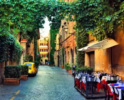 Beautiful ancient street in Rome lined with leafy vines and cafe