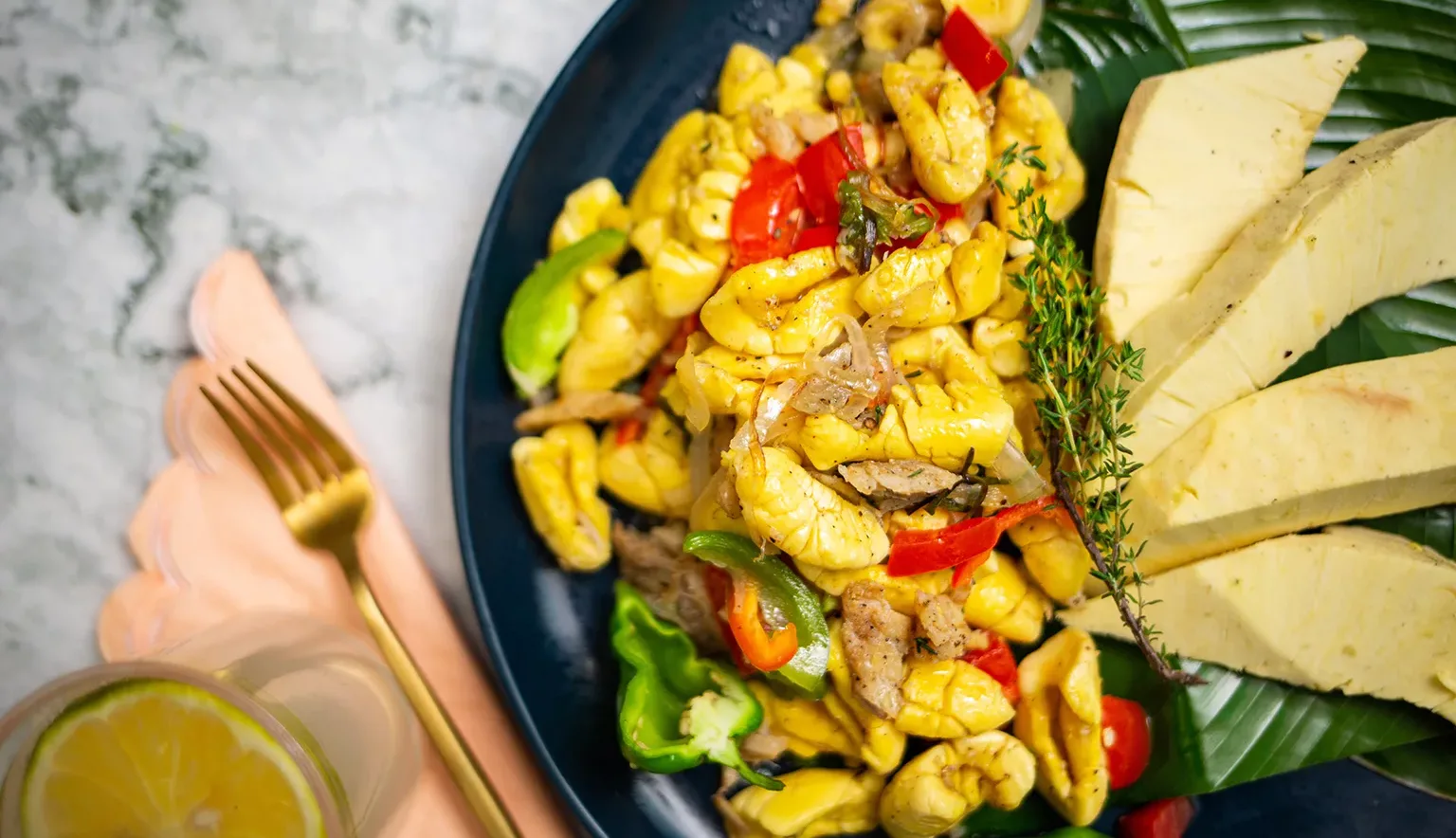 Ackee and Saltfish with Breadfruit in Dark Blue Plate - Closeup