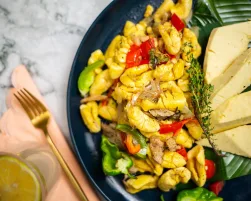 Ackee and Saltfish with Breadfruit in Dark Blue Plate - Closeup
