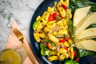 Ackee and Saltfish with Breadfruit in Dark Blue Plate - Closeup
