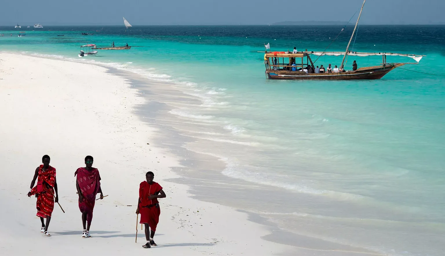 Masai, entertaining tourists on the beach in Nungwi. Zanzibar