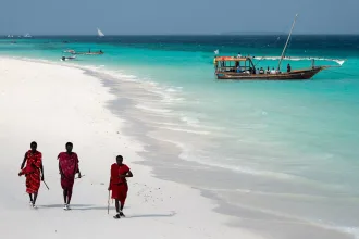 Masai, entertaining tourists on the beach in Nungwi. Zanzibar