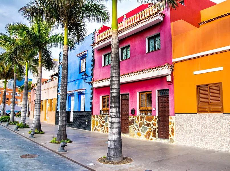Tenerife. Colourful houses and palm trees on street in Puerto de la Cruz town, Tenerife, Canary Islands, Spain