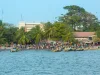 African people and boats on the shoreline of Banjul in Gambia, West Africa
