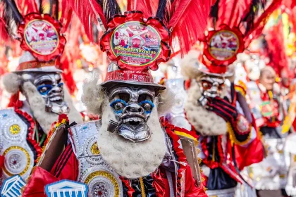 man in red mask at The festival of the Santísima Trinidad