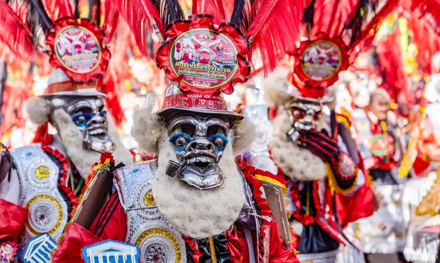 man in red mask at The festival of the Santísima Trinidad
