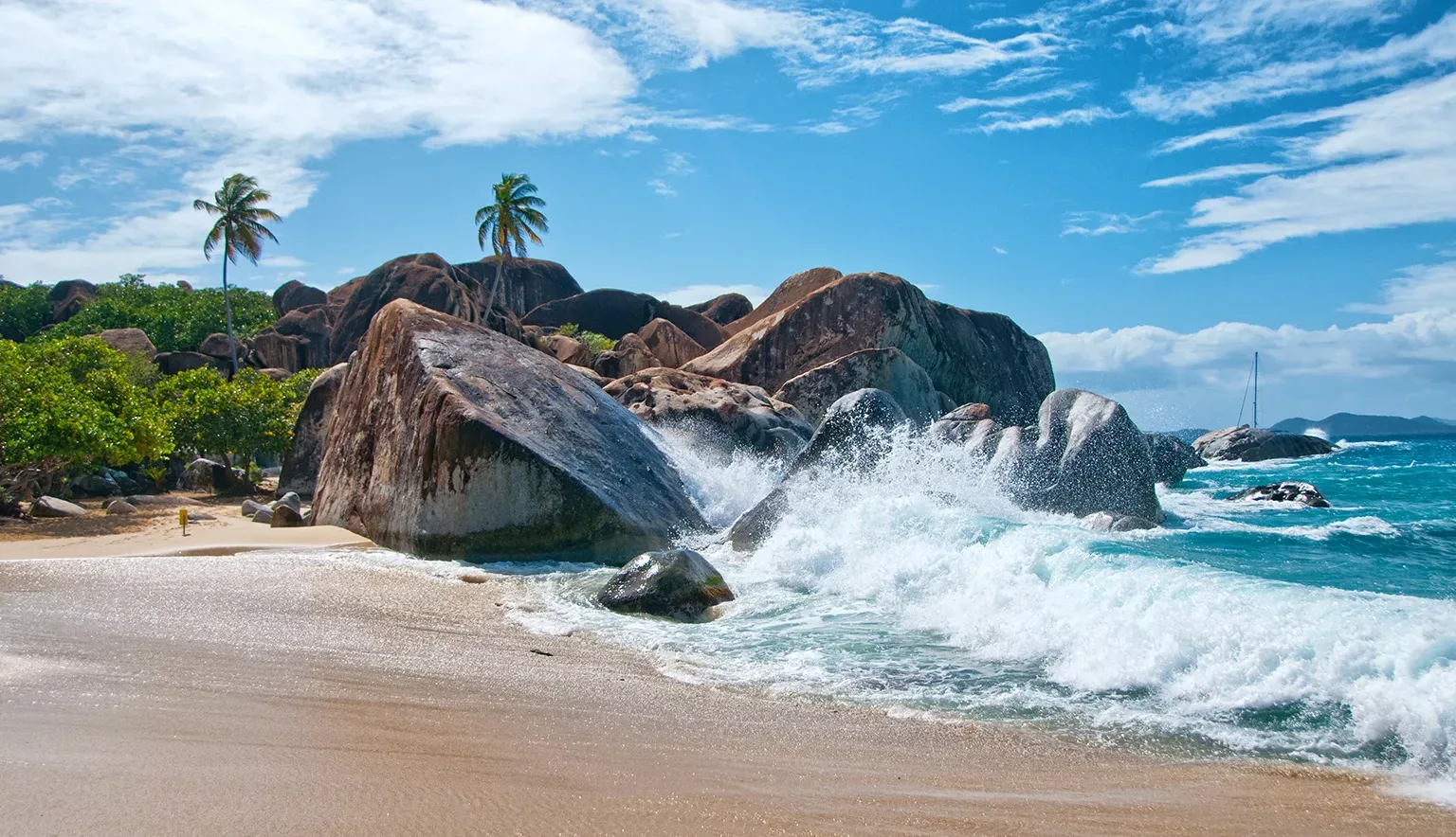 Water Splash at Virgin Gorda Island with Big Rocks, Plants and Trees on a Tropical Climate.