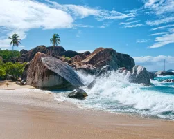 Water Splash at Virgin Gorda Island with Big Rocks, Plants and Trees on a Tropical Climate.
