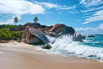 Water Splash at Virgin Gorda Island with Big Rocks, Plants and Trees on a Tropical Climate.